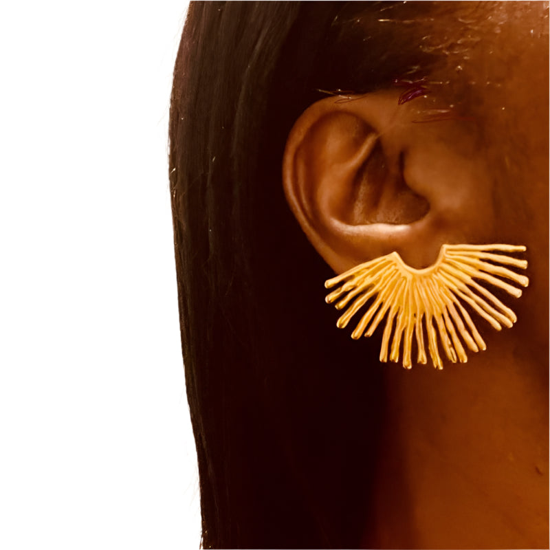 lady wearing gold spiked earrings