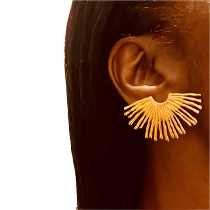 lady wearing gold spiked earrings